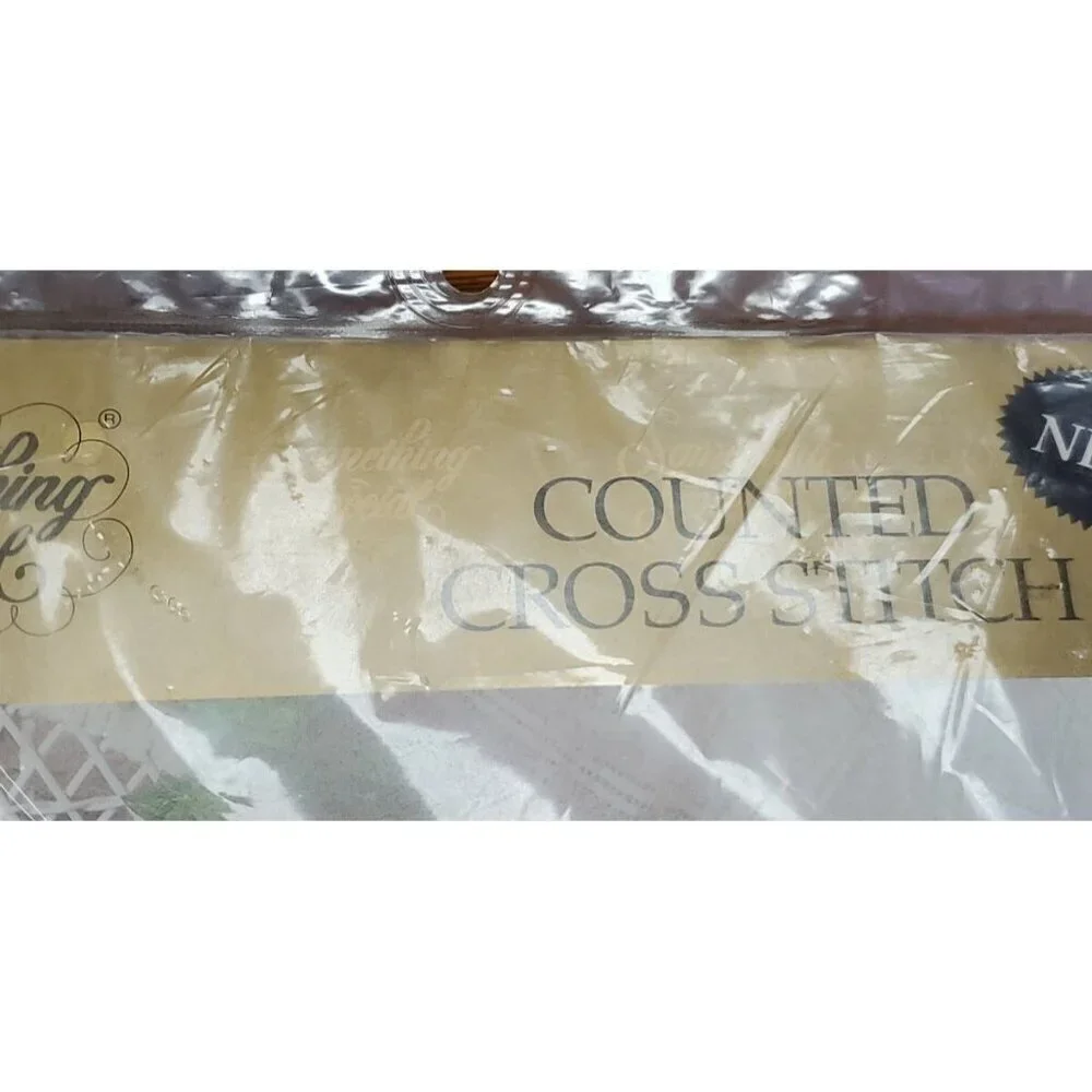 Something Special Counted Cross Stitch Kit #50687 wreath on black pillow.
